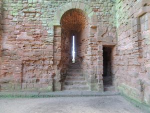 The thin windows of the time that protected against attack but allowed little light