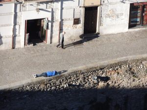 Some guy relaxing far below on the wall